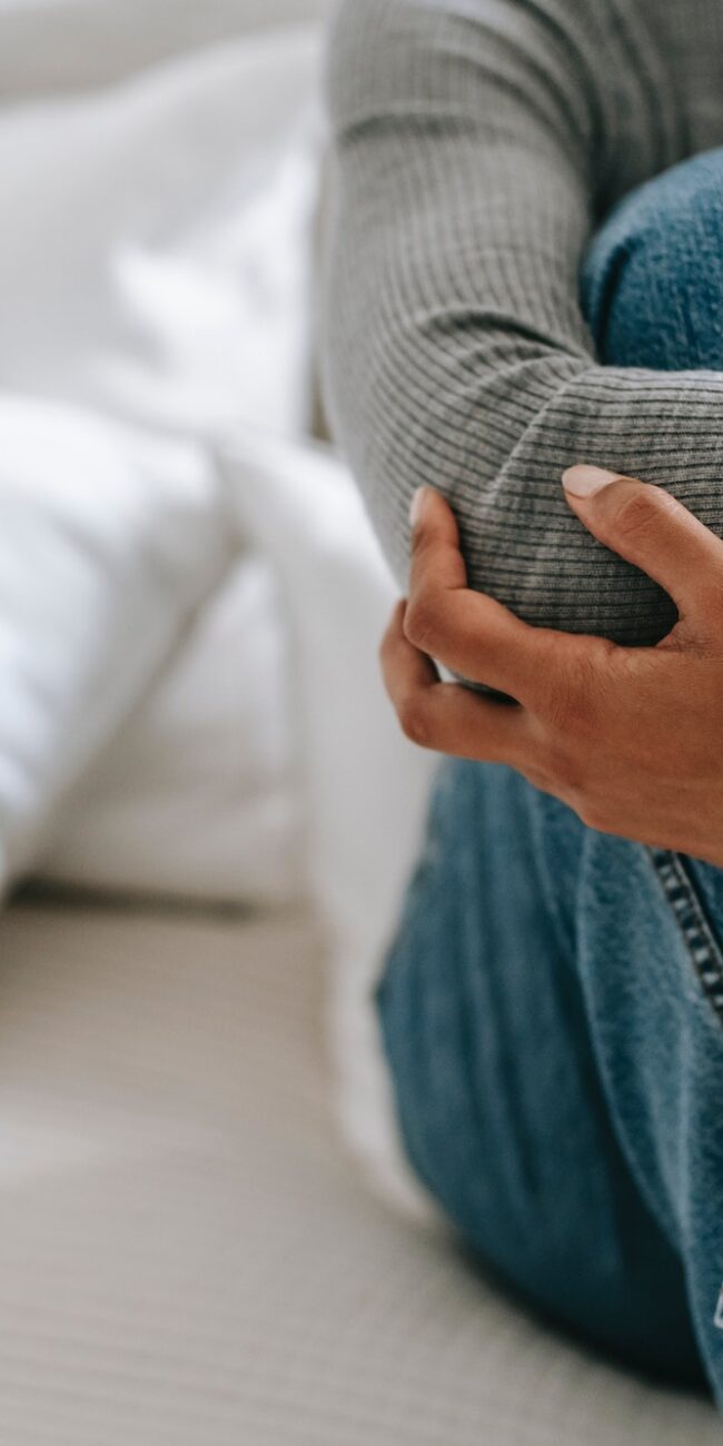 woman hugging knees